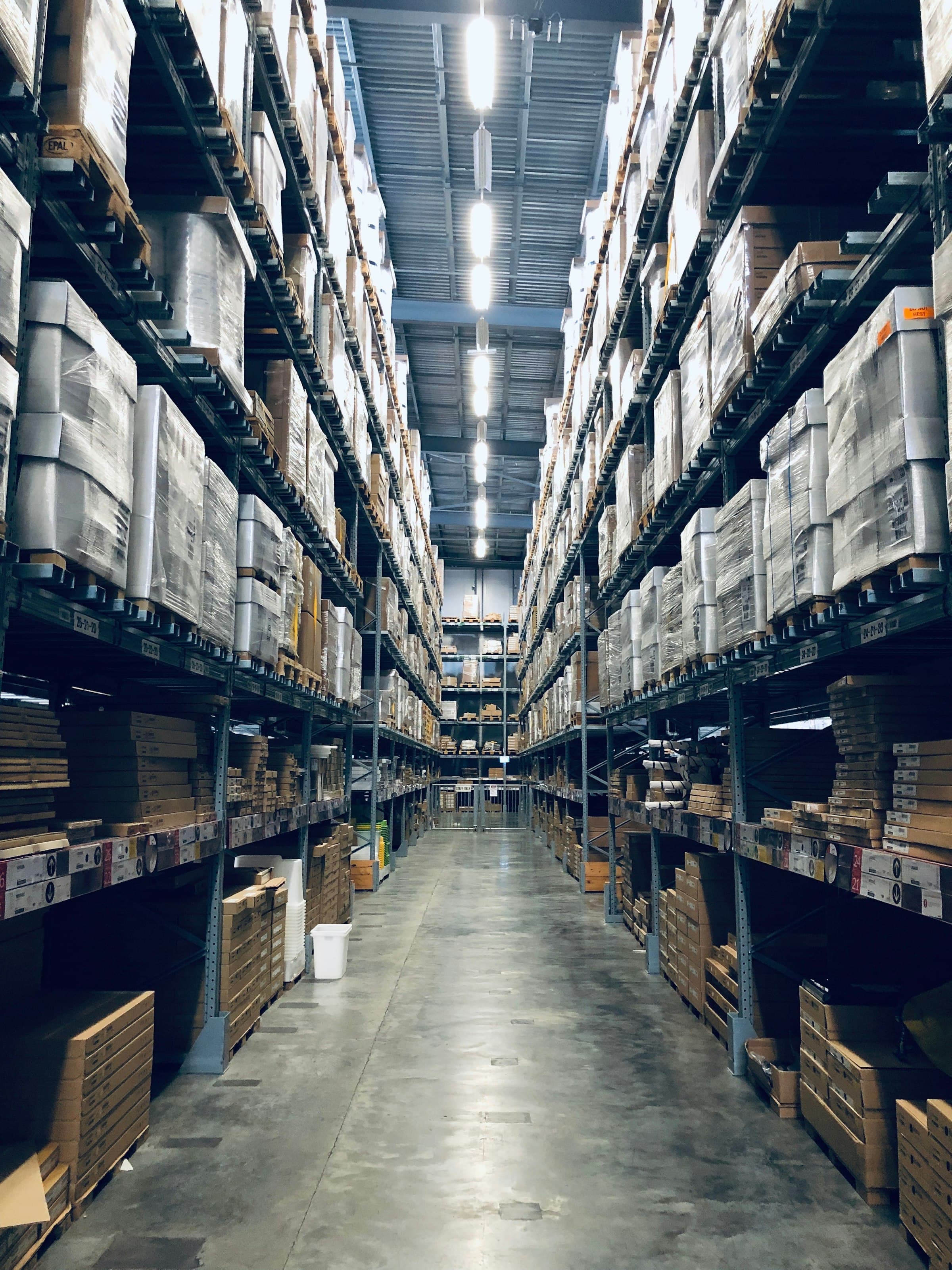 Tall stockroom shelves lined with labeled boxes