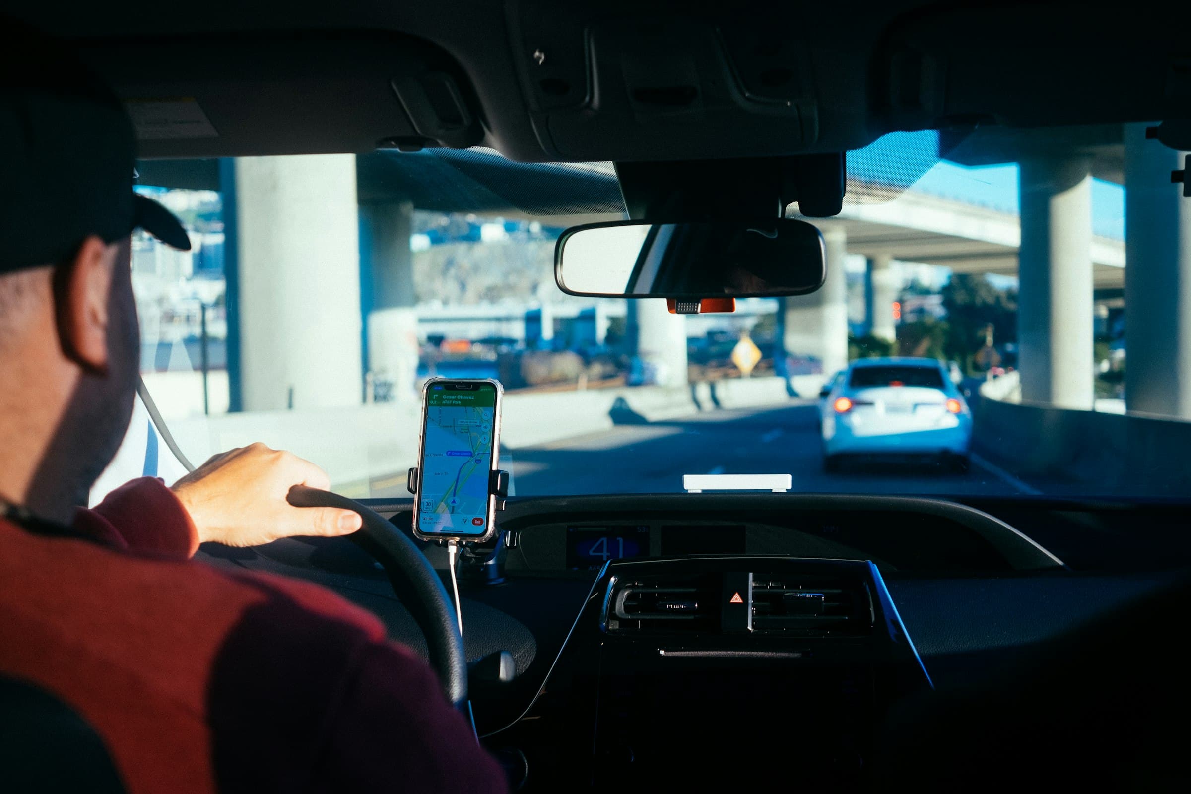 A crew member drives to the morning’s first install, route on the phone