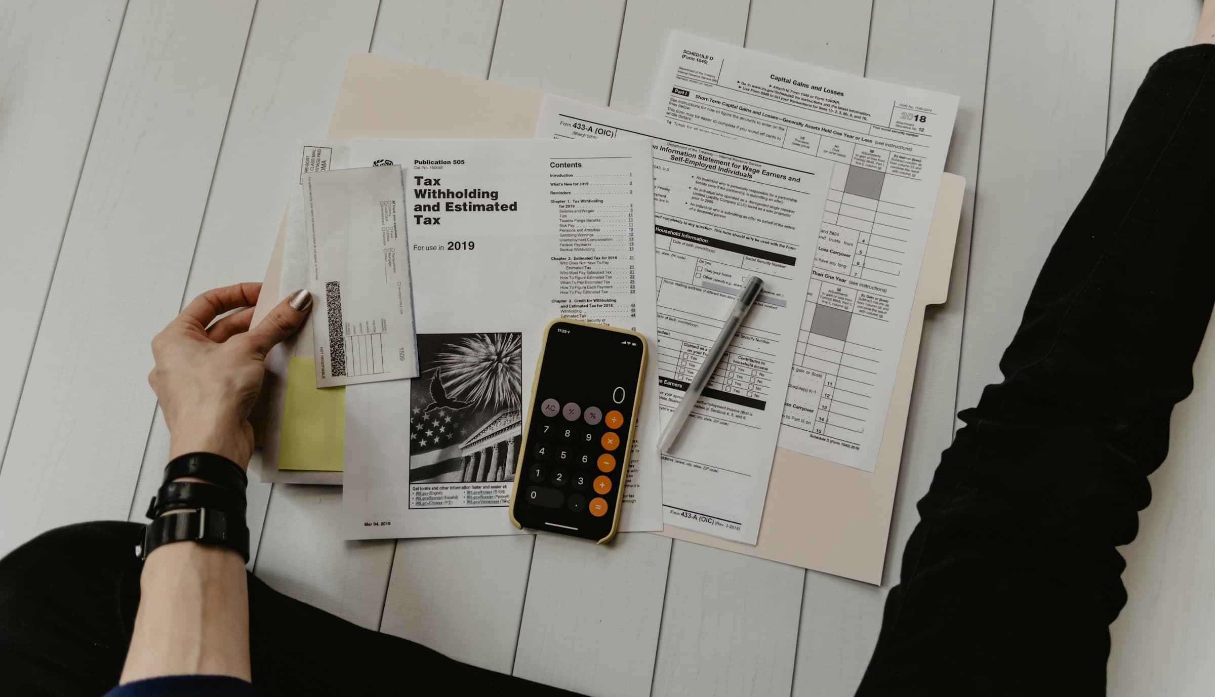 Receipts, forms, and a calculator spread out for end-of-month books